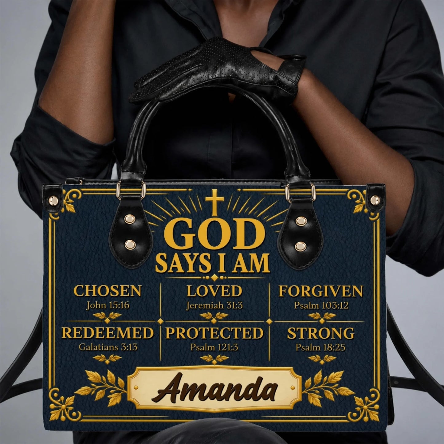 Stylish navy handbag with religious typography, Bible verses, and the name Amanda, held by a woman wearing gloves.