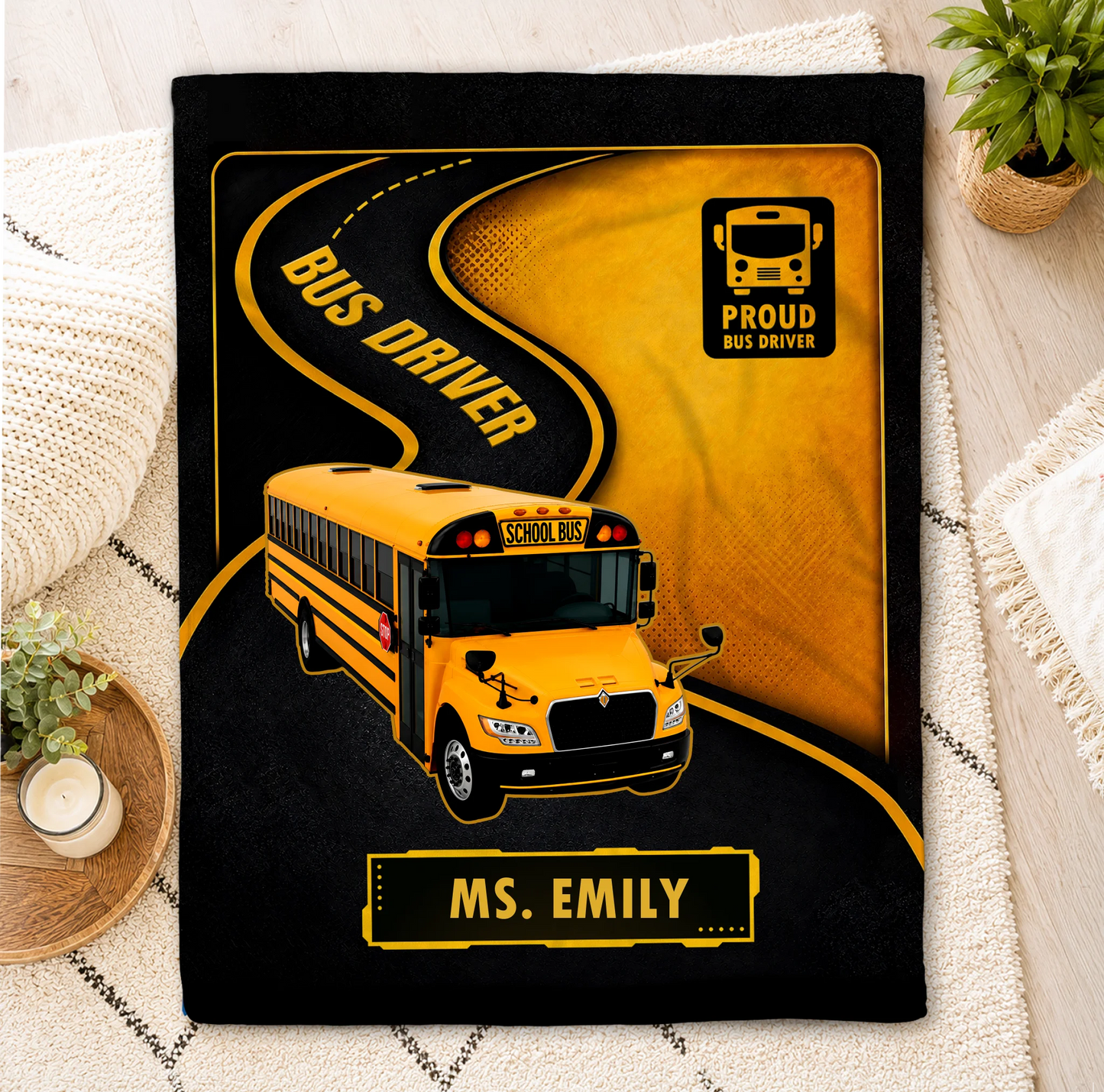A personalized bus driver throw blanket with school bus design and Ms. Emily text, ideal gift for bus drivers.
