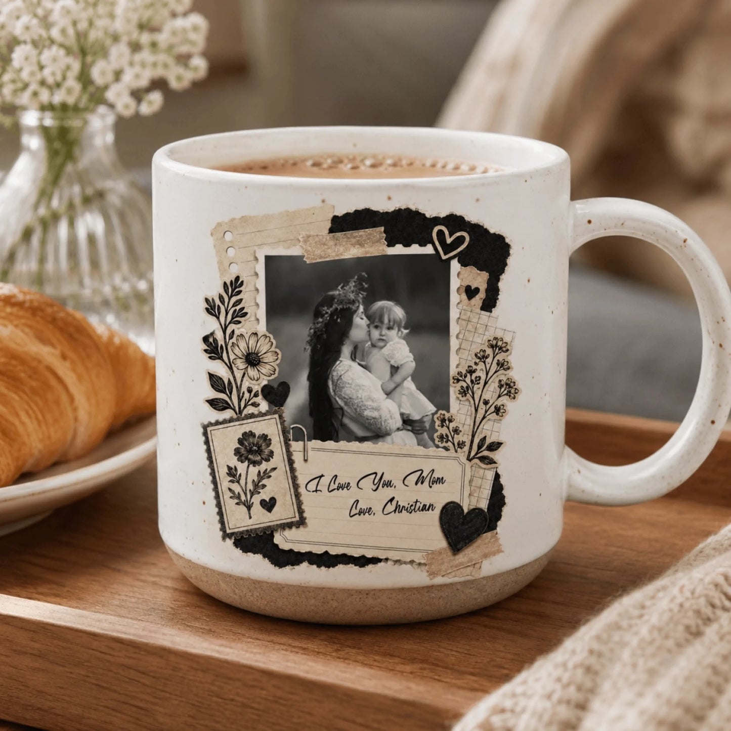 A white ceramic mug with a decorative scrapbooking-style design featuring a black and white photo and floral accents.