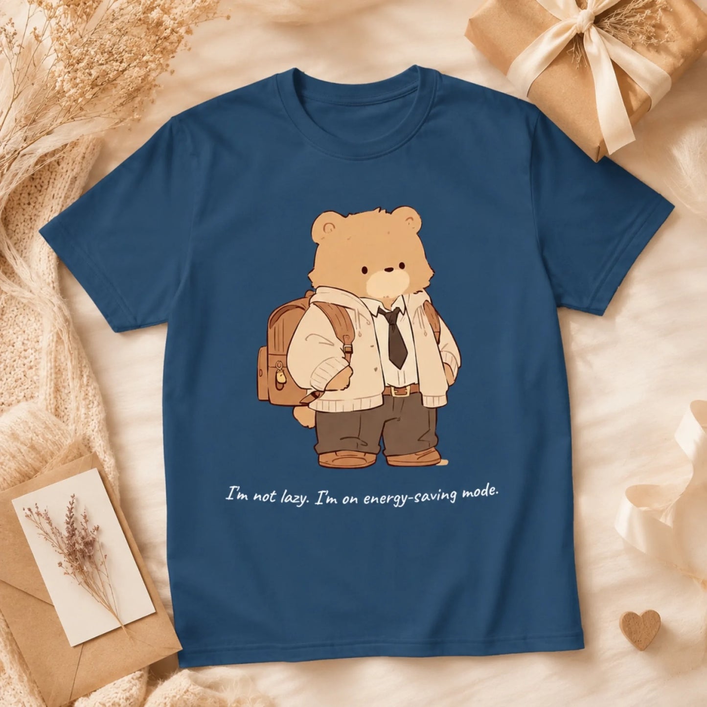 Blue t-shirt with a bear graphic and text on a decorative background