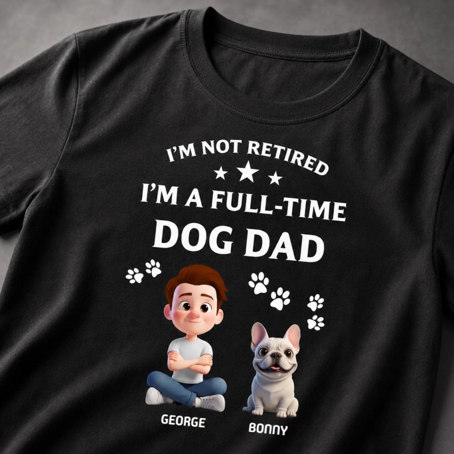 Black t-shirt with a graphic of a man and dog with text 'I'm not retired, I'm a full-time dog dad' on a gray background.