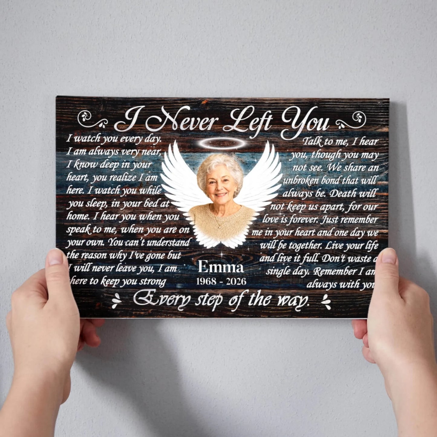 Hands holding a custom memorial canvas with angel photo frame and remembrance quote for a celebration of life.