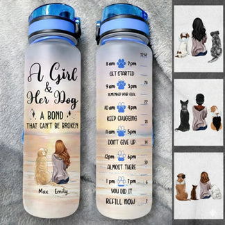 Two water bottles with dog-themed designs and text on a gray surface.
