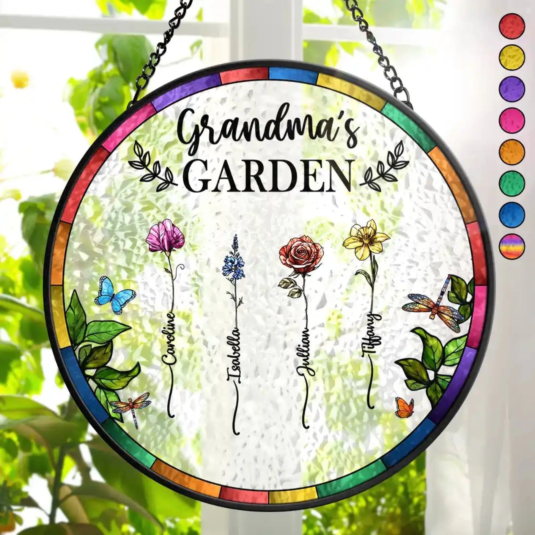 Decorative glass panel with 'Mama Garden' text and floral designs, hanging against a blurred greenery background.