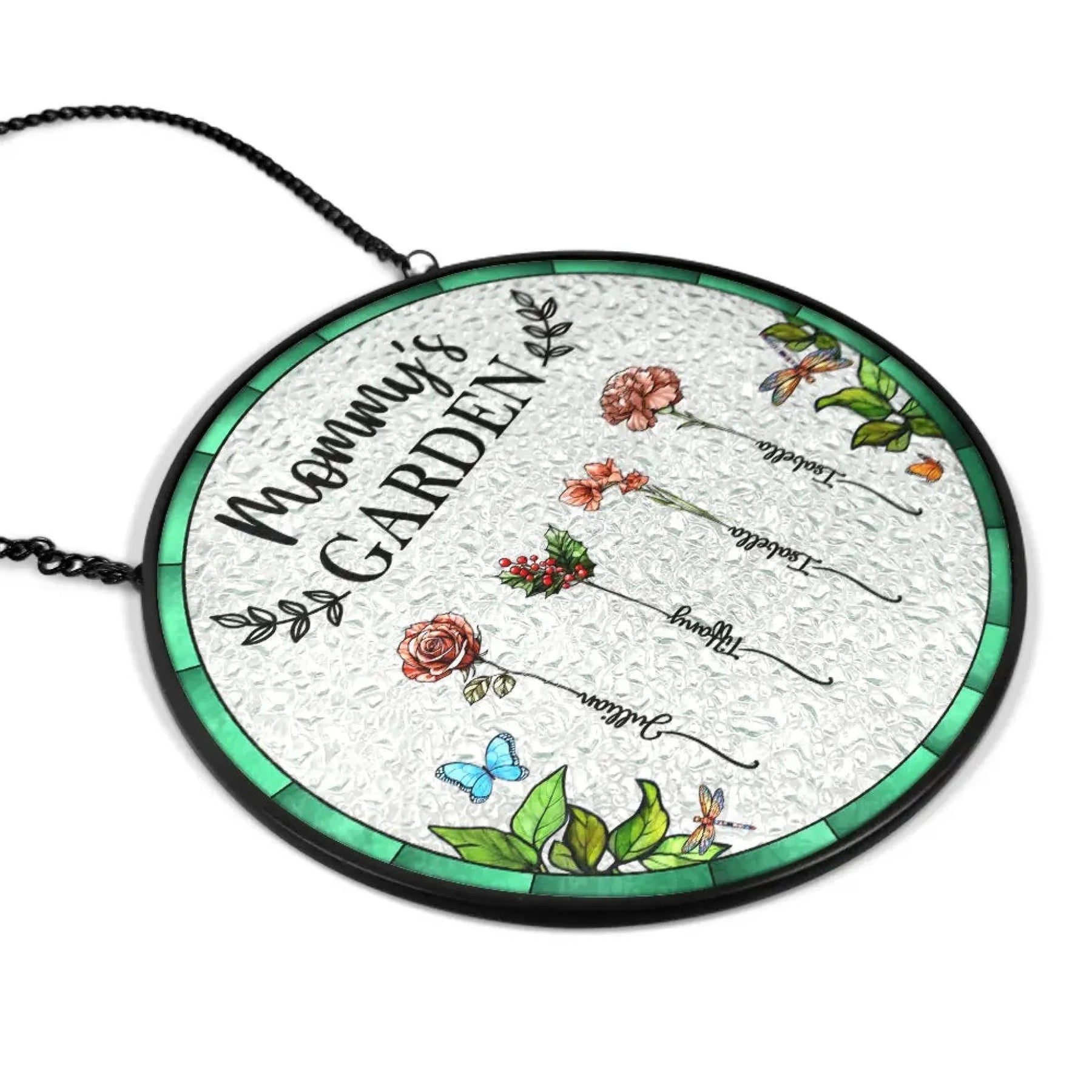 Decorative glass panel with 'Mama Garden' text and floral designs, hanging against a blurred greenery background.