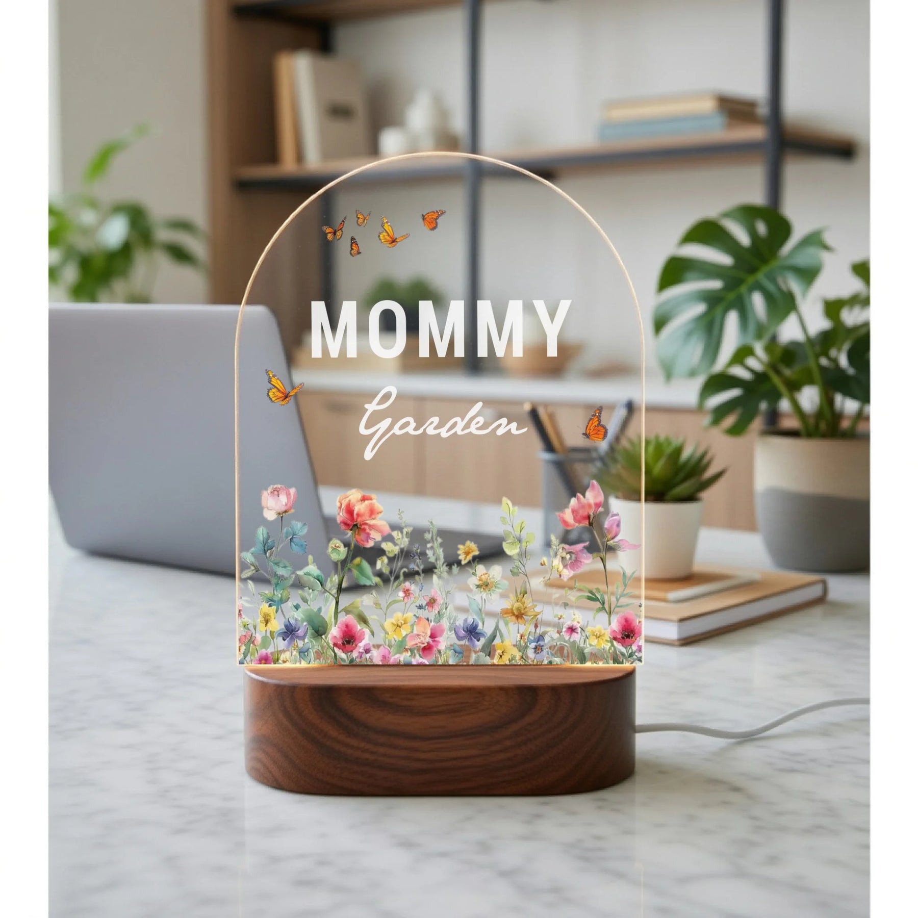 Decorative lamp with 'Mommy Garden' text on a marble surface in a home setting.