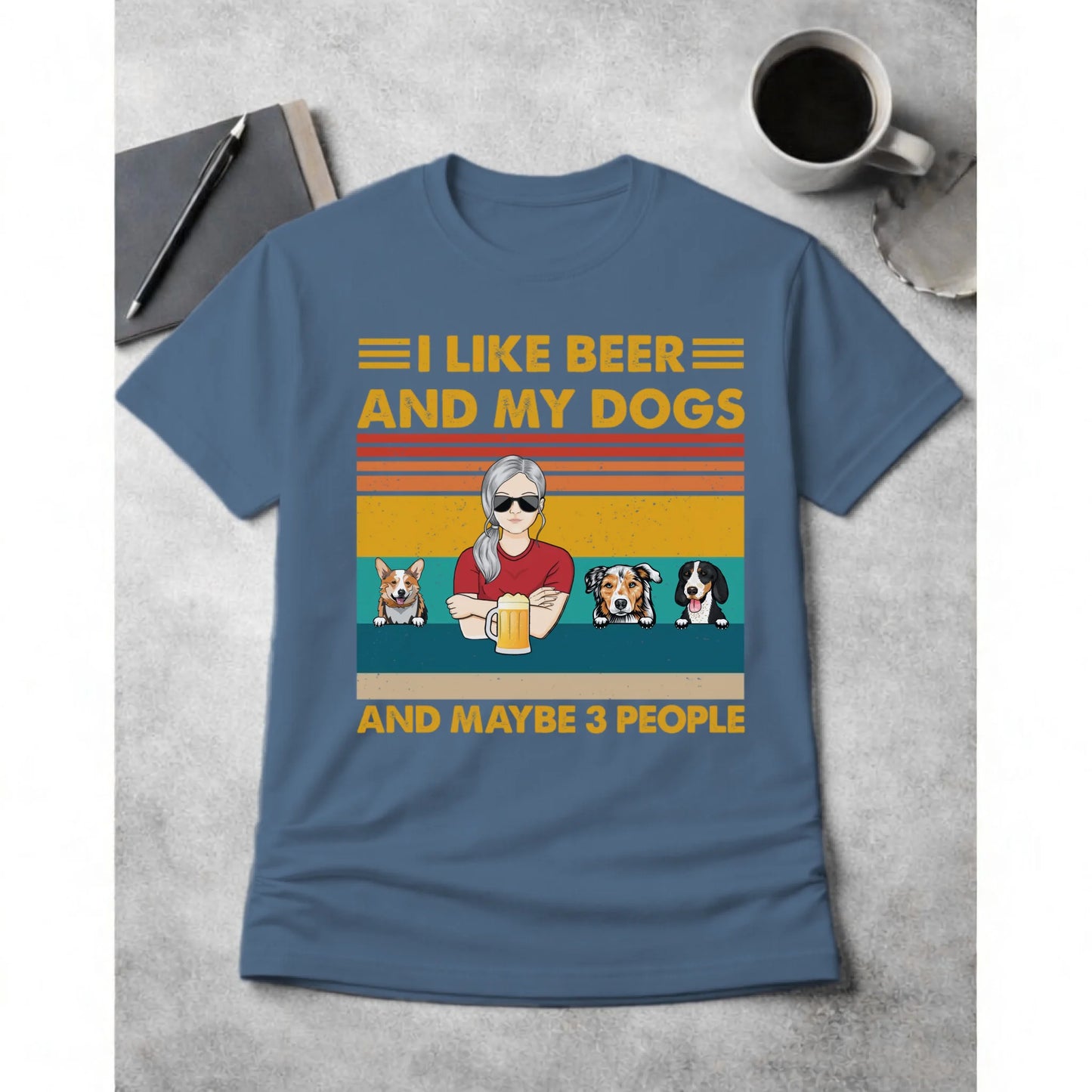 Blue t-shirt with graphic design of a person with dogs and text on a concrete surface.