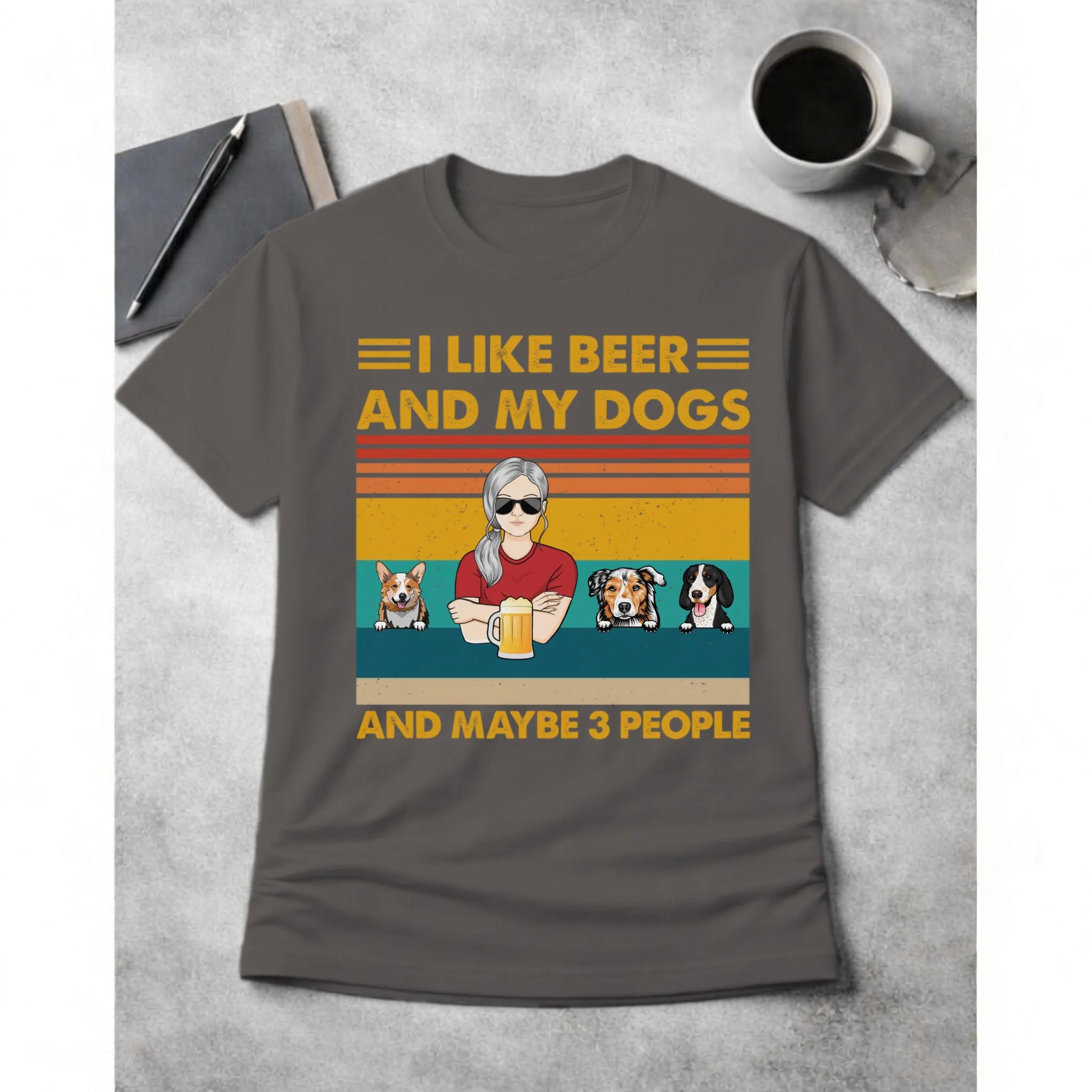 Gray t-shirt with a graphic design featuring a person with sunglasses, beer, and dogs on a concrete surface.