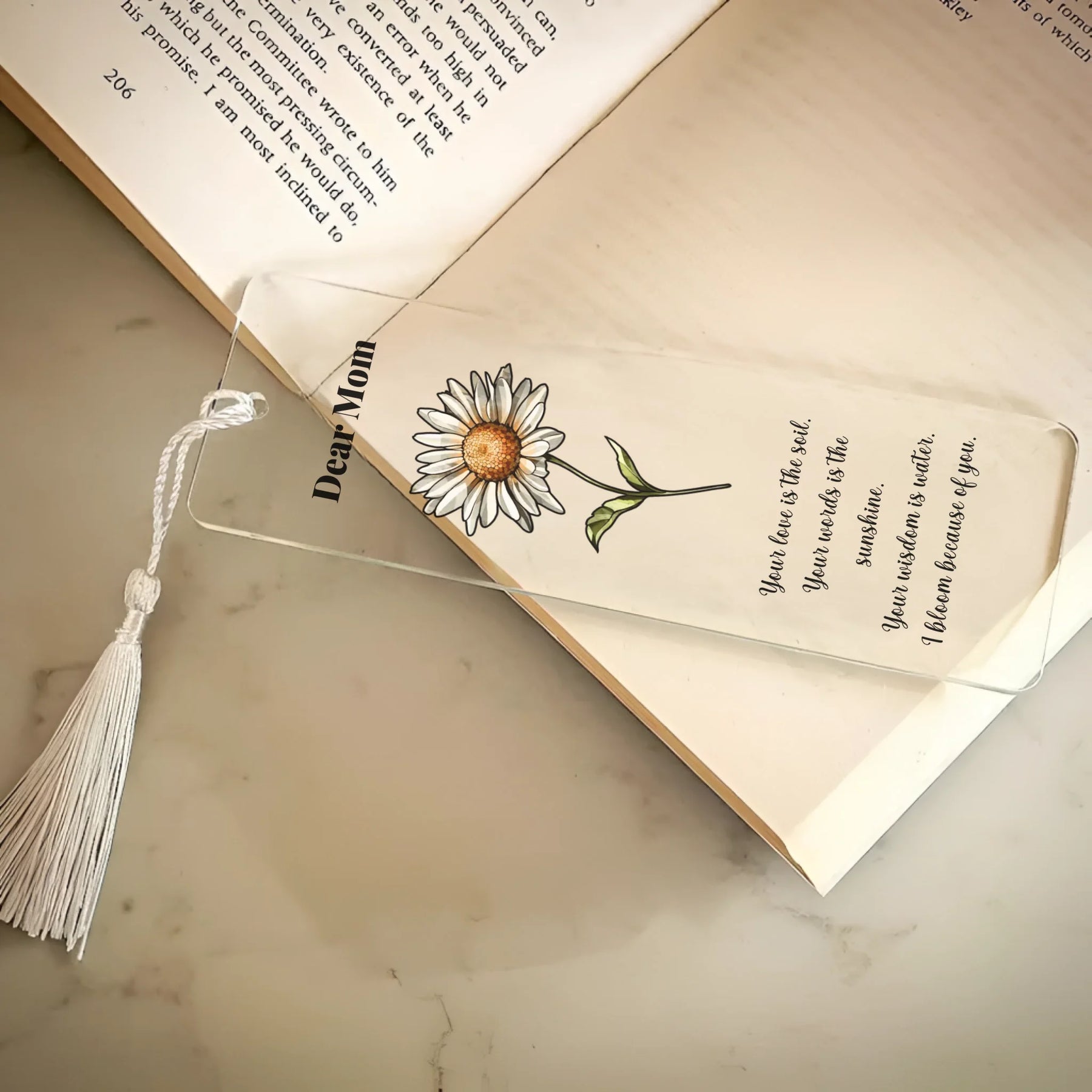 Floral bookmark with tassel on an open book