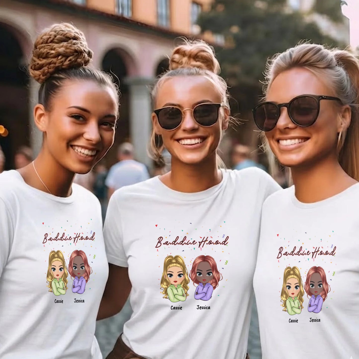 Three women wearing white t-shirts with cartoon characters and text, standing outdoors.