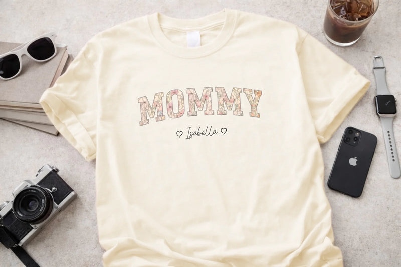 Personalized mommy t-shirt in ivory with floral block letters and custom names front view - Jollimate