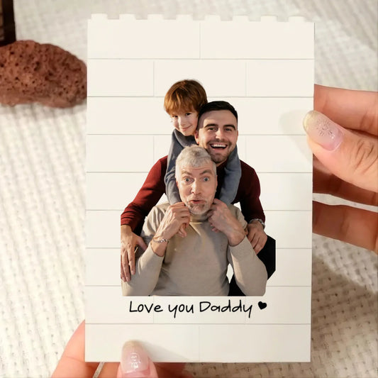 Three generations of men posing together with 'Love you Daddy' text on a white background