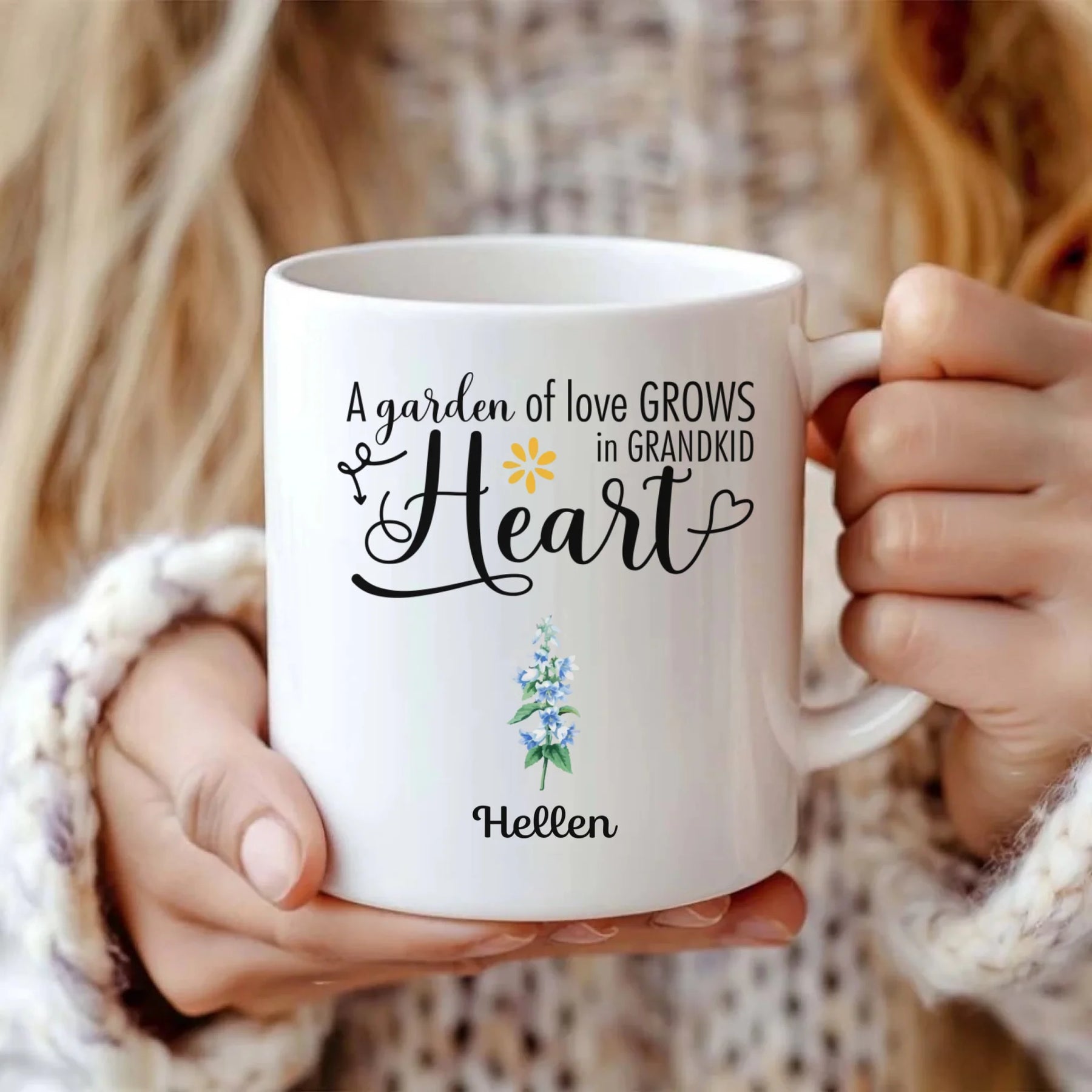 Personalized white coffee mug featuring the quote "A garden of love grows in grandkids' heart" with custom names Sophia and Hellen and floral illustrations.