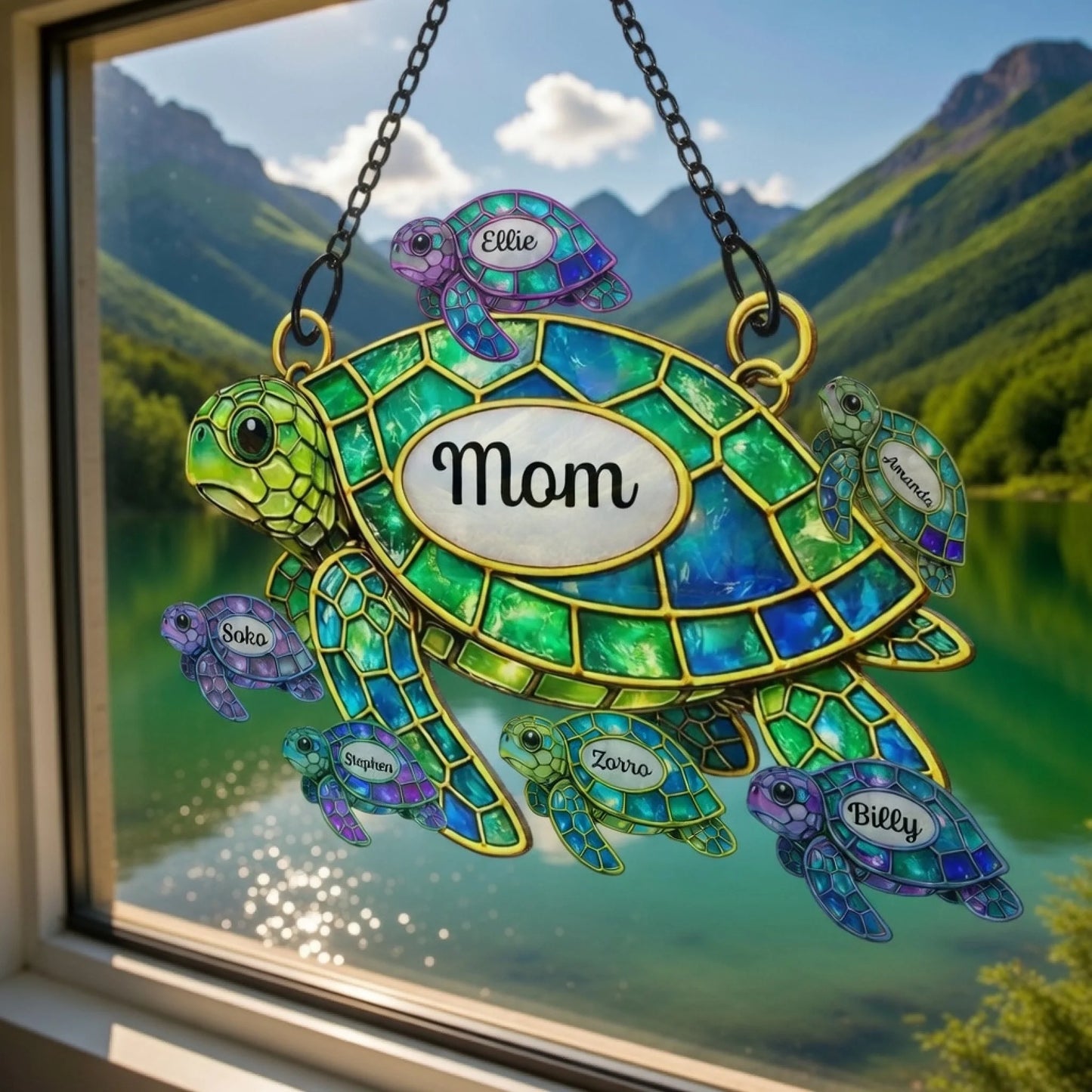 Decorative stained glass turtle with 'Mom' on a mountain lake background