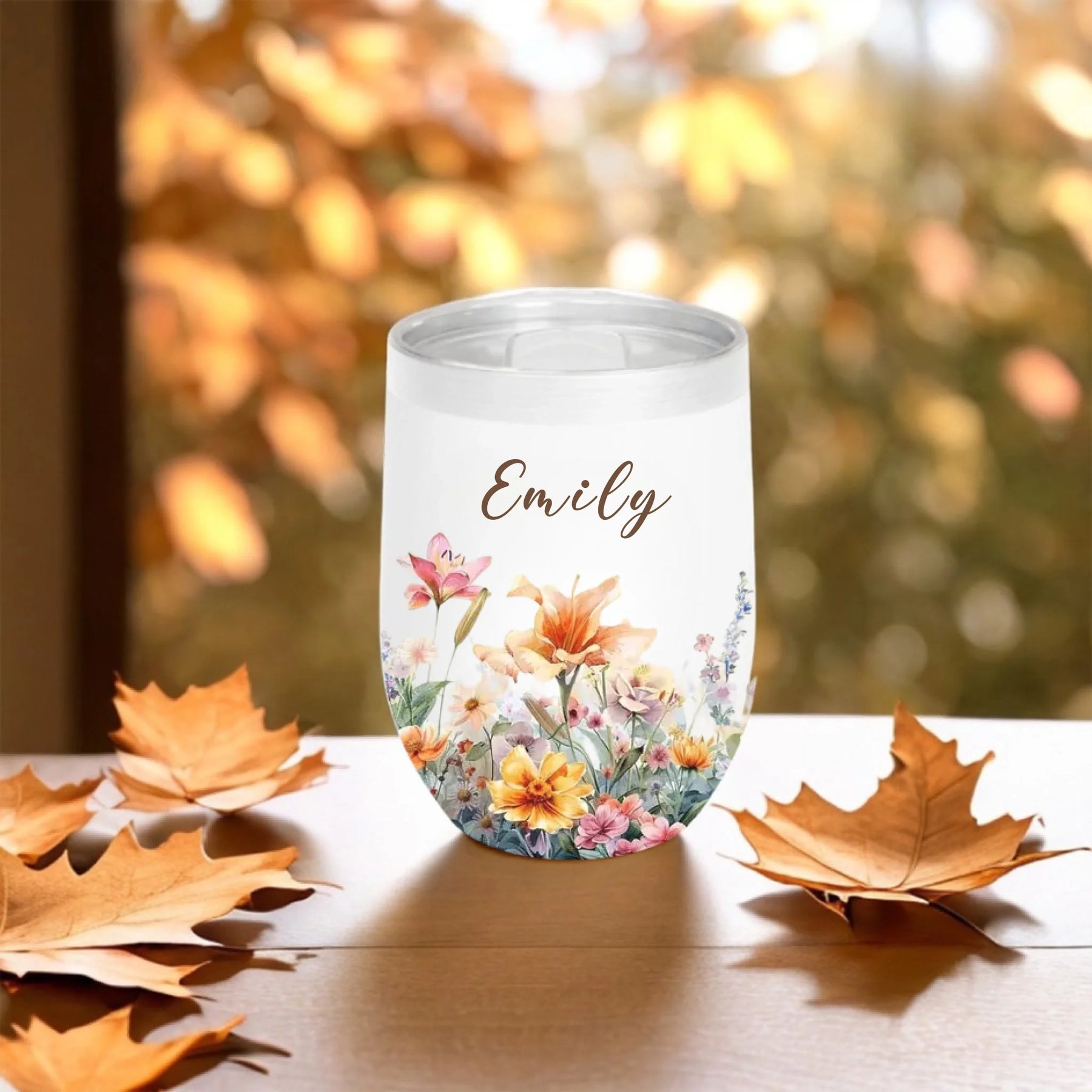 personalized floral tumbler with name emily fall background close up - Jollimate
