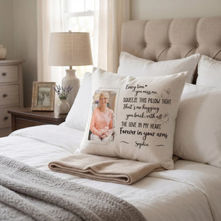 Personalized memorial pillow with photo and heartfelt message placed on beige sofa in cozy sunlit living room