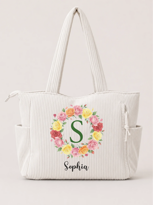 Personalized corduroy tote bag in white with colorful floral wreath and custom name front view - Jollimate