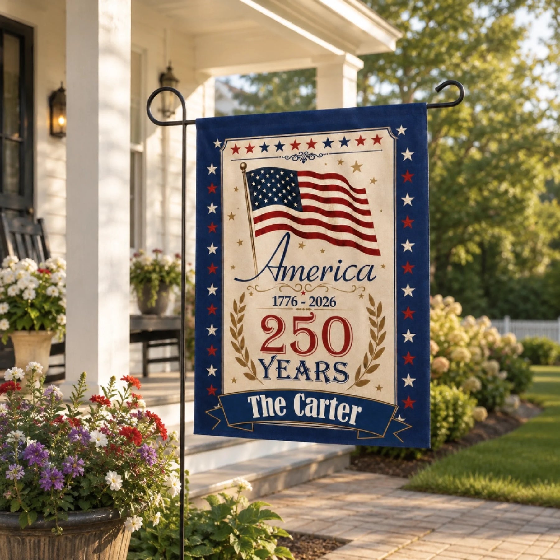 Decorative garden flag celebrating America's 250th anniversary in a garden setting.