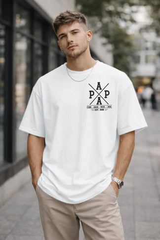 Man wearing a white t-shirt with a logo on a city street