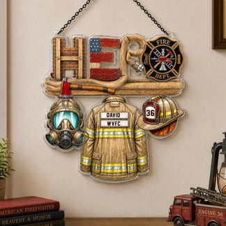 A clear acrylic hanging ornament shaped like "HERO" with firefighter elements including a uniform, helmet, and gas mask.
