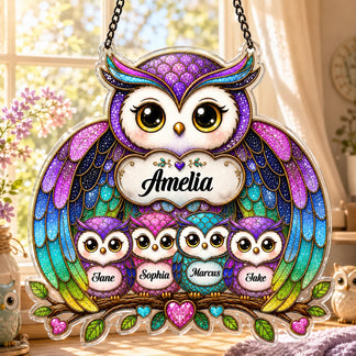 Colorful owl family ornament with names on a blurred background