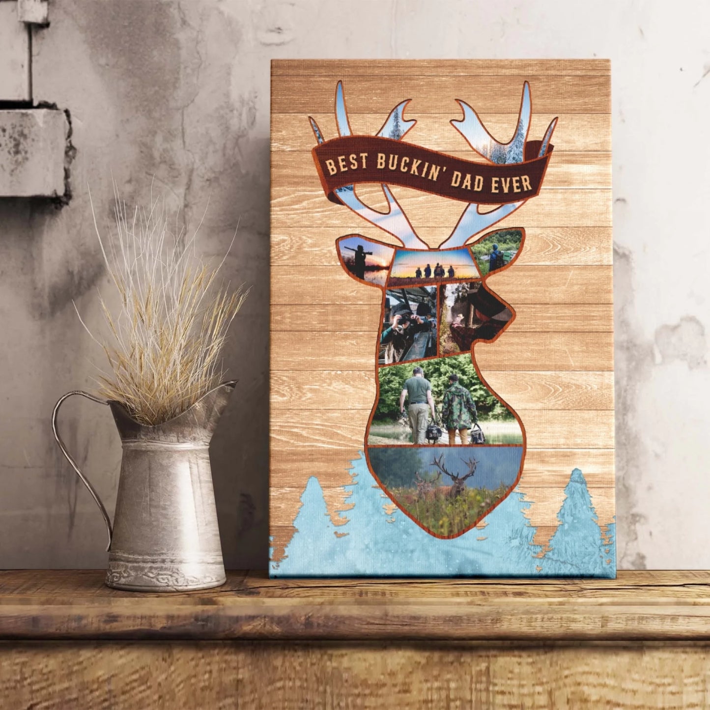 Vertical canvas print displaying a deer head photo collage with a "BEST BUCKIN' DAD EVER" banner and blue pine trees, on a wooden shelf.