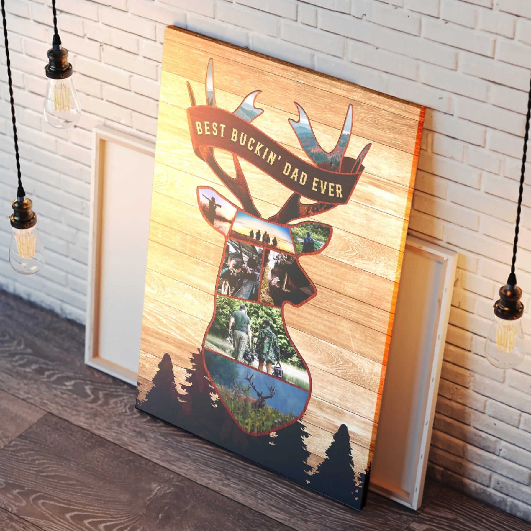 Vertical canvas print displaying a deer head photo collage with a "BEST BUCKIN' DAD EVER" banner and dark pine trees, leaning against a white brick wall under warm lights.