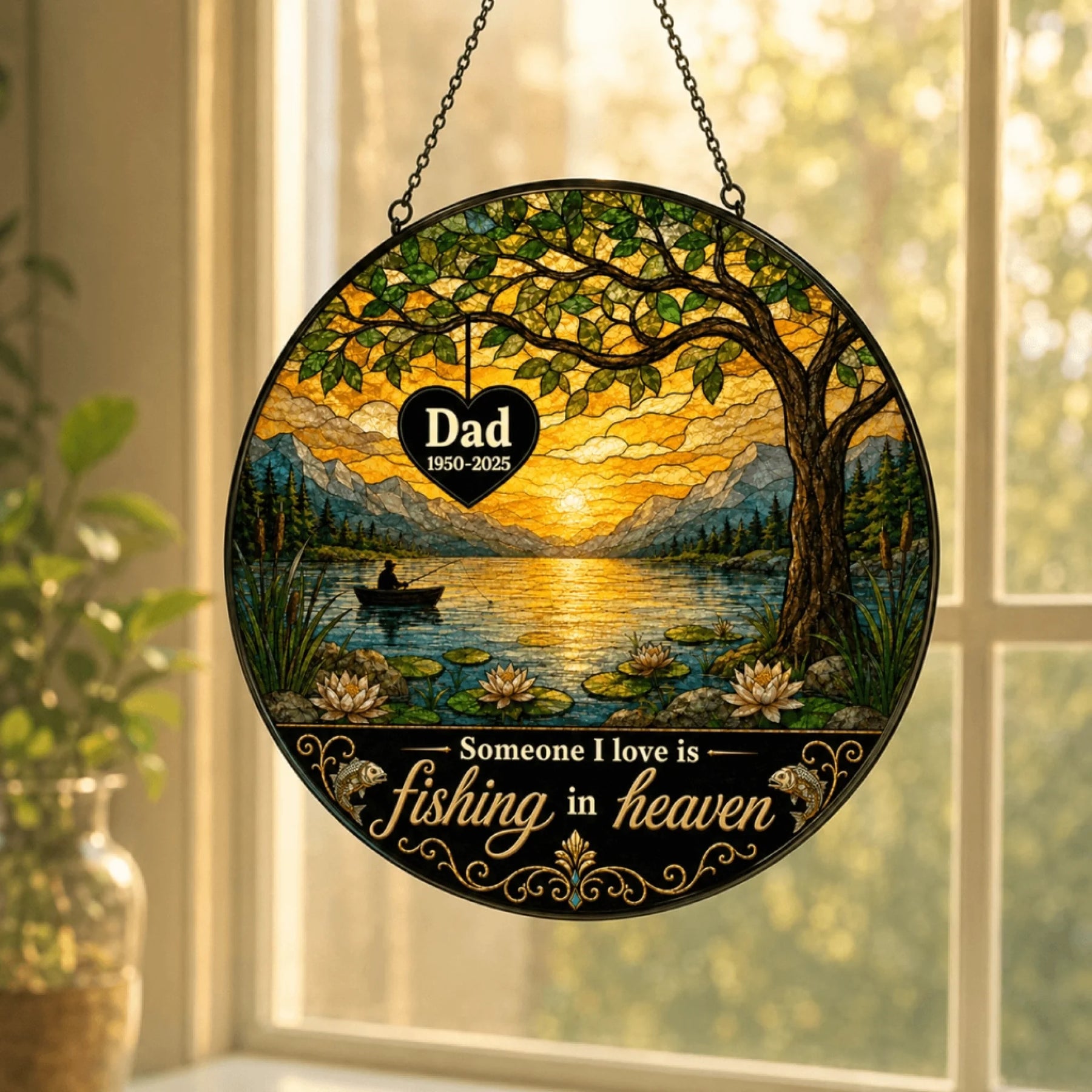 Round stained glass-style panel with a fishing scene, visible personalized text, and a sunset glow, hanging inside a window.