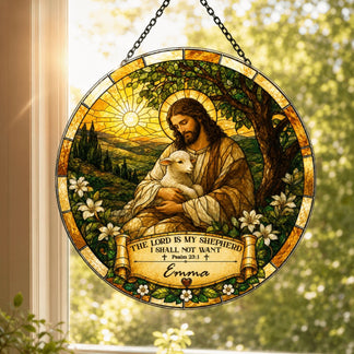 A circular stained-glass style suncatcher hangs in a window, showing a shepherd figure with lambs, bathed in sunlight. A banner reads "Emma".