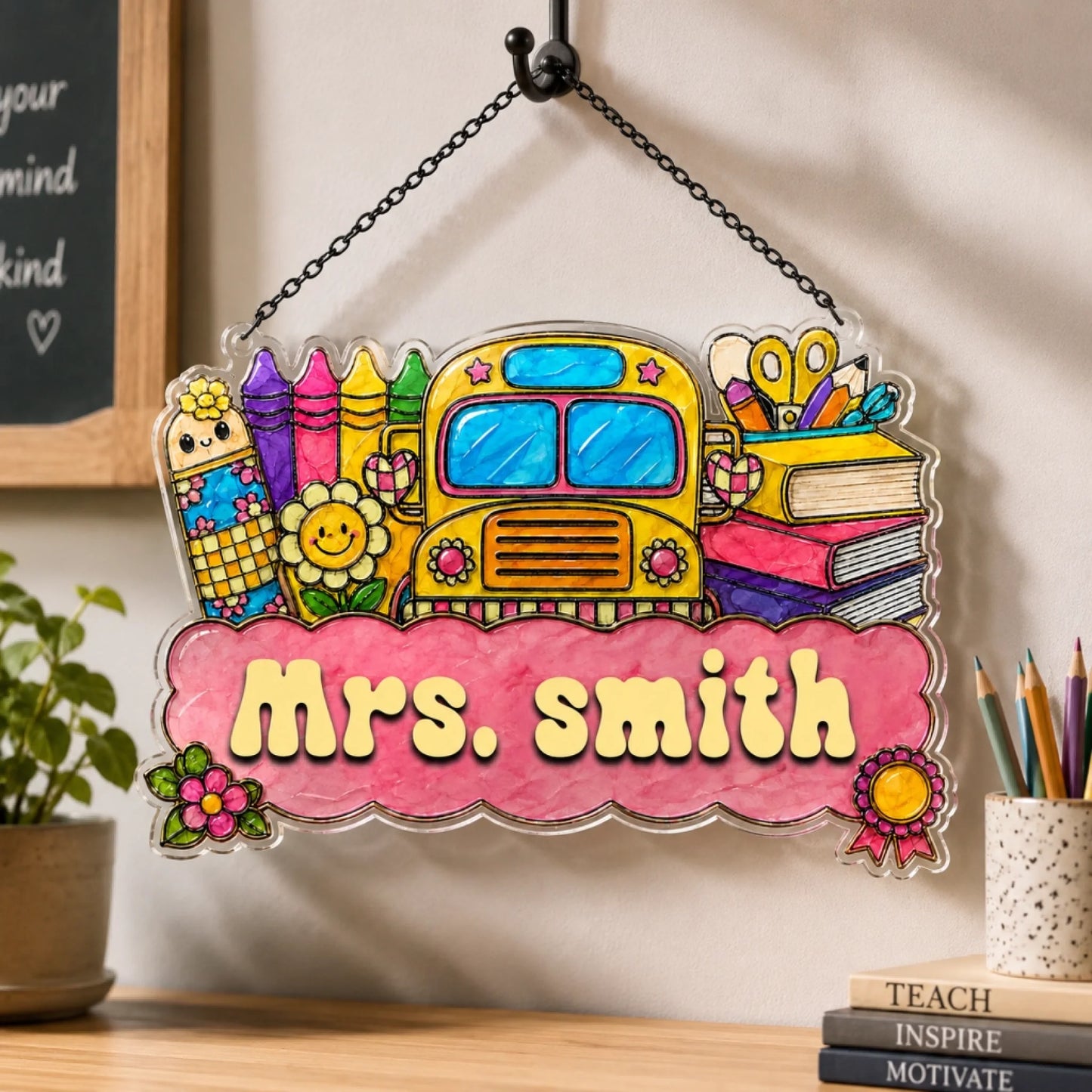 A vibrant school-themed sign featuring a yellow bus, crayons, and books. "Mrs. Smith" is visible on a pink banner.