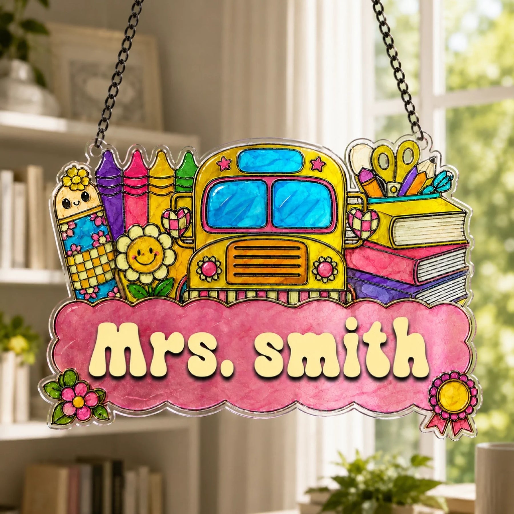 A vibrant school-themed sign featuring a yellow bus, crayons, and books, with "Mrs. Smith" on a pink banner, in front of a window.