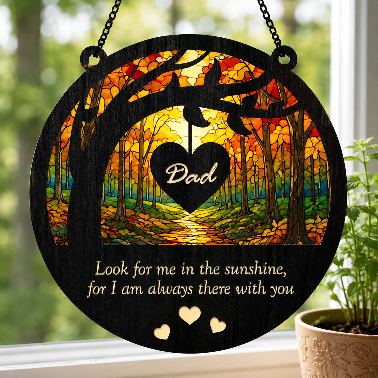 Decorative plaque with 'Dad' heart design and forest scene, hanging indoors.