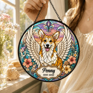 Close-up of a person holding a circular stained glass style art piece depicting a winged corgi with personalized text.