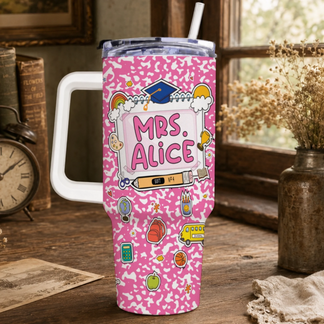 Pink travel tumbler with a white handle, lid, and straw. It features a school-themed design with 'MRS. ALICE' and various colorful illustrations.