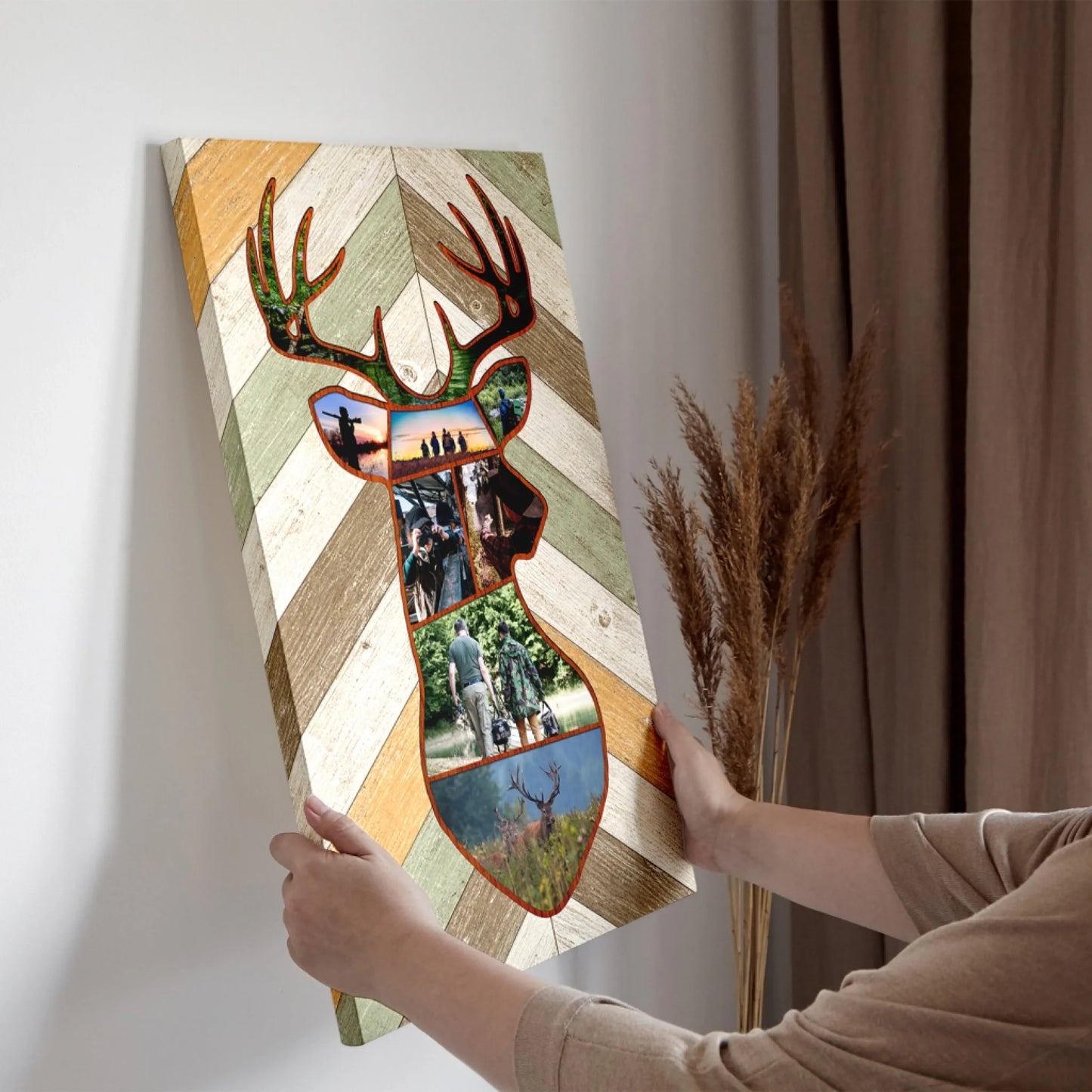 Person holding a decorative wall art piece shaped like a deer with photo collage inside.