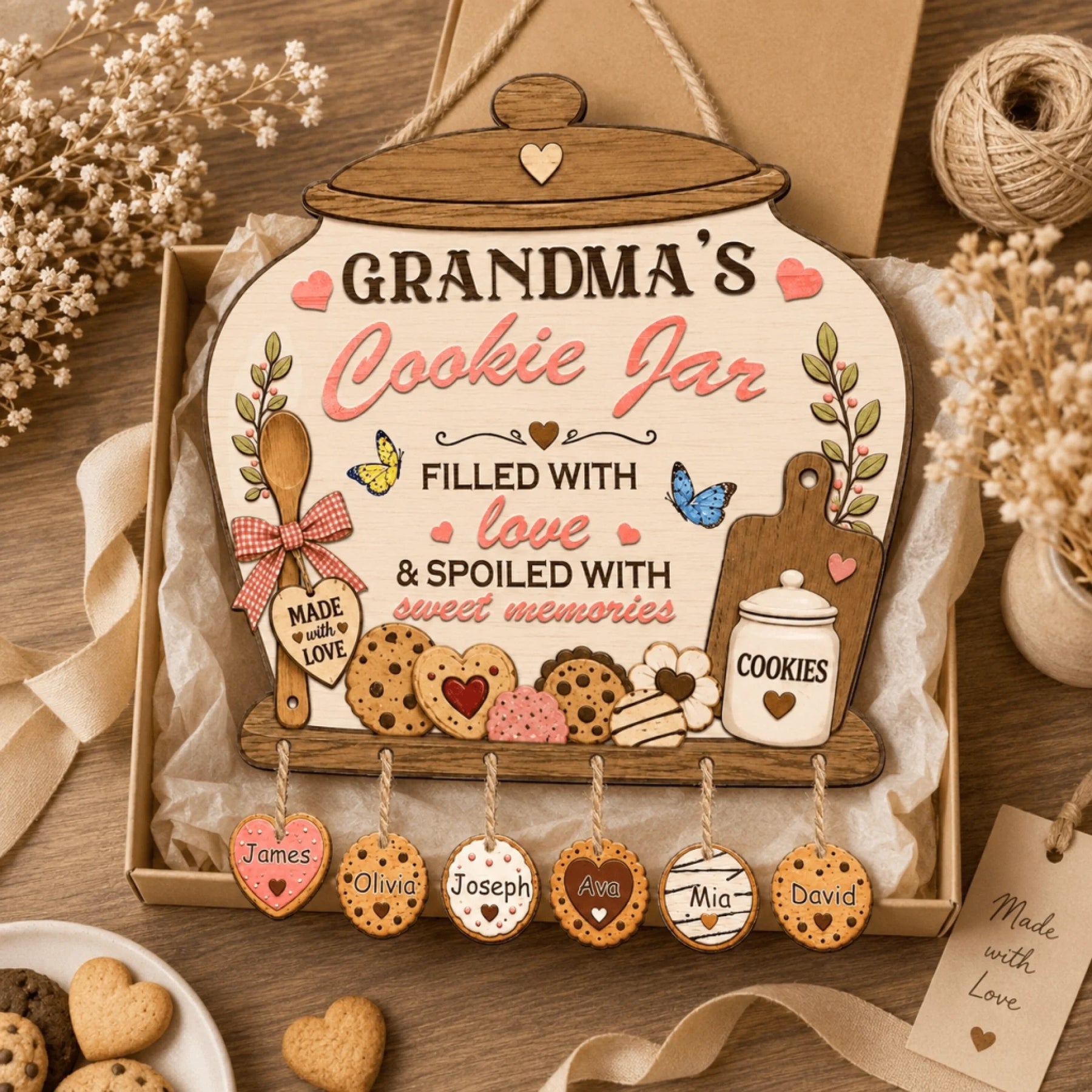 Decorative cookie jar sign with personalized name tags on a wooden surface.