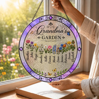Round decorative sign with 'Grandma's Garden' and floral designs, held by a person in front of a window with flowers outside.