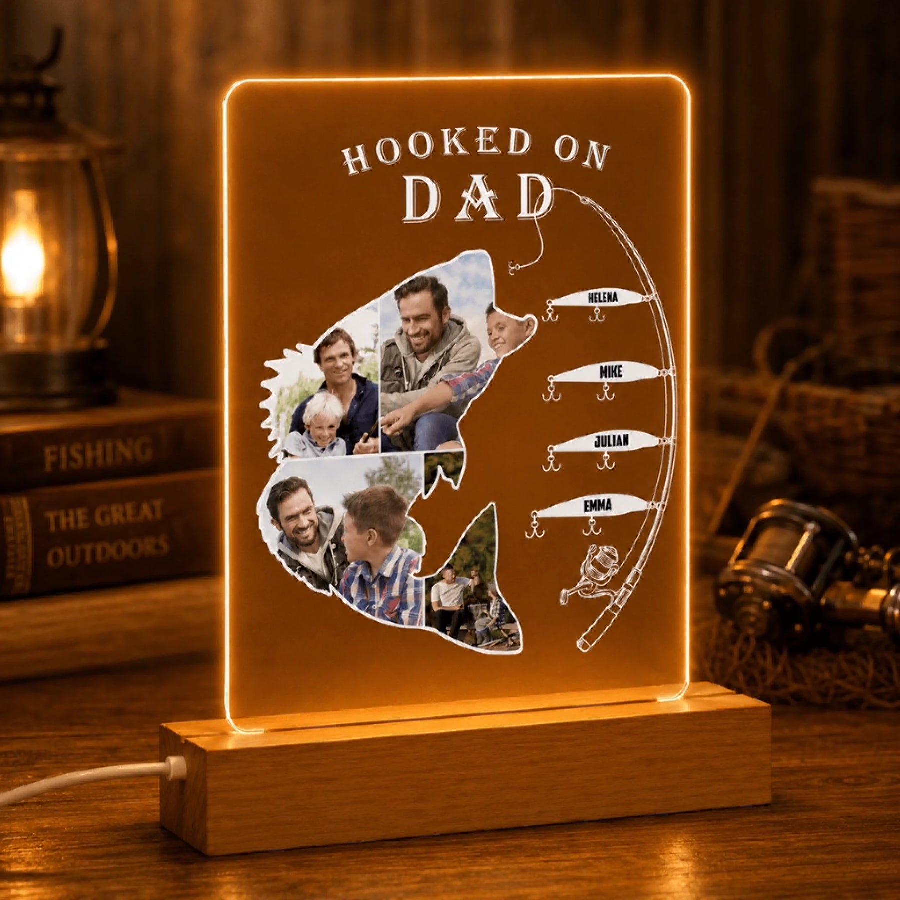 LED sign shaped like a fish with 'Hooked on Dad' text and family photos, placed on a wooden surface.