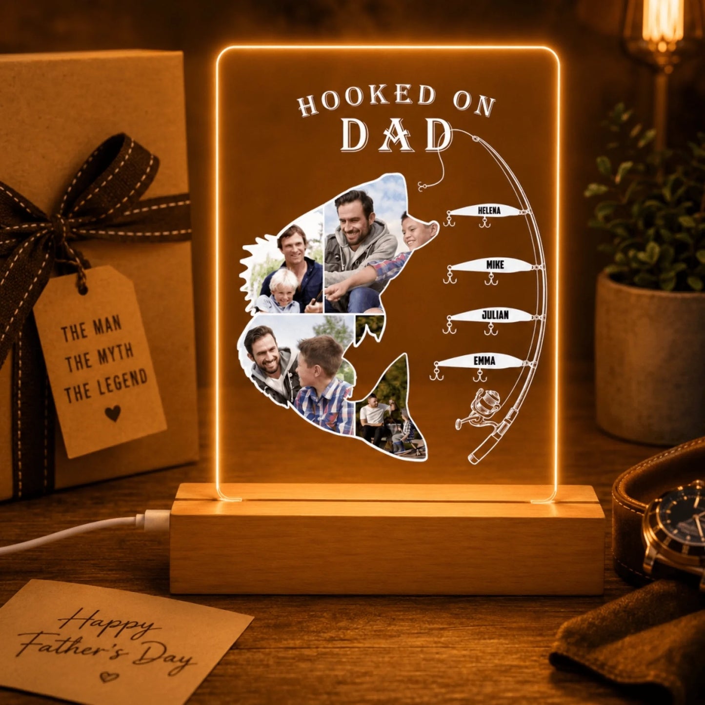 Decorative light with fishing theme and family photos, placed on a wooden surface with a gift and card in the background.