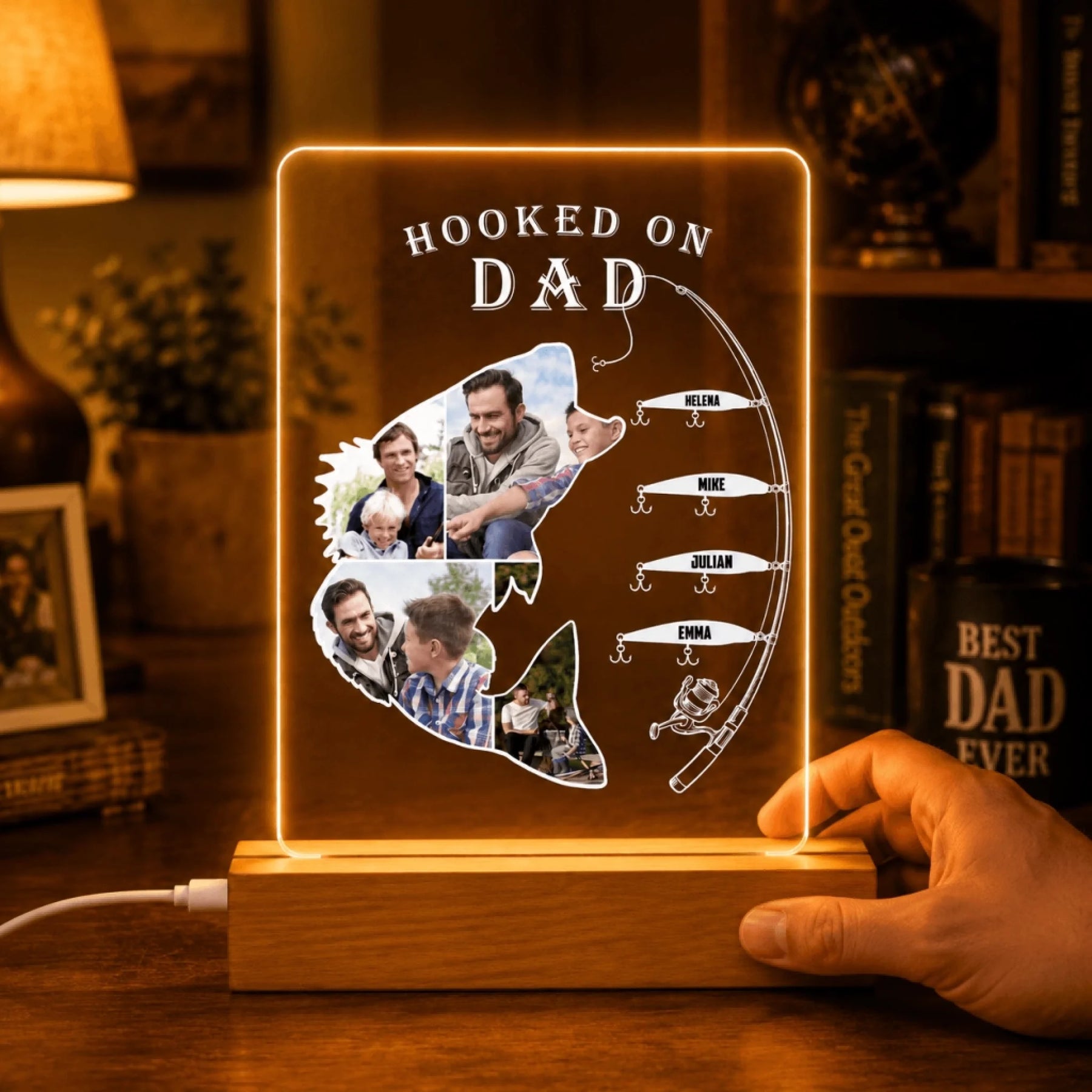 Personalized light-up sign shaped like a fish with family photos and 'Hooked on Dad' text.