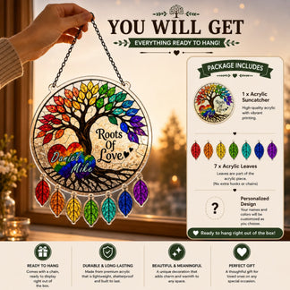 Rainbow-themed acrylic sun catcher with personalized text, held by a hand against a blurred indoor background.