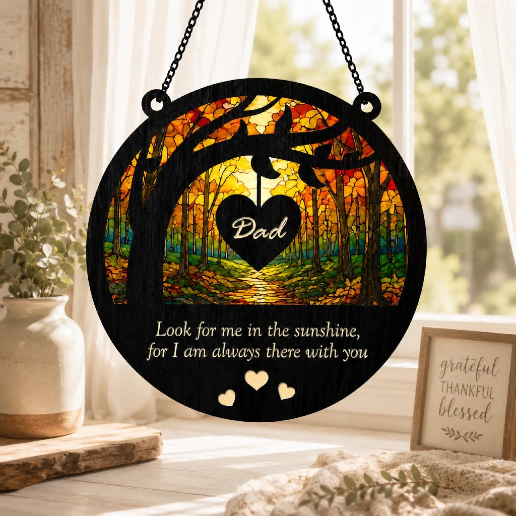 Decorative hanging sign with 'Dad' and a heart-shaped design, placed on a windowsill.