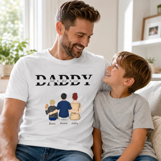 Man wearing a white t-shirt with 'DADDY' and family illustrations, sitting with a child on a couch.