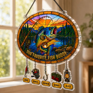 Stained glass panel with fish design and personalized names, hanging by a window.