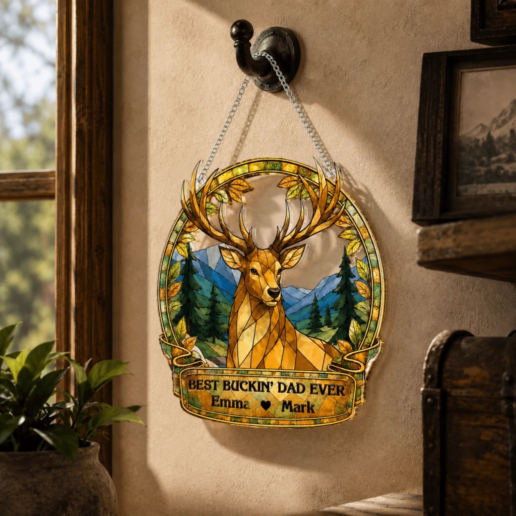 Decorative plaque with a deer design and text hanging on a wall.
