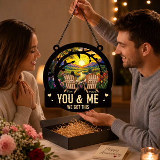 Couple holding a decorative sign with 'You & Me We Got This' message in a warm indoor setting.