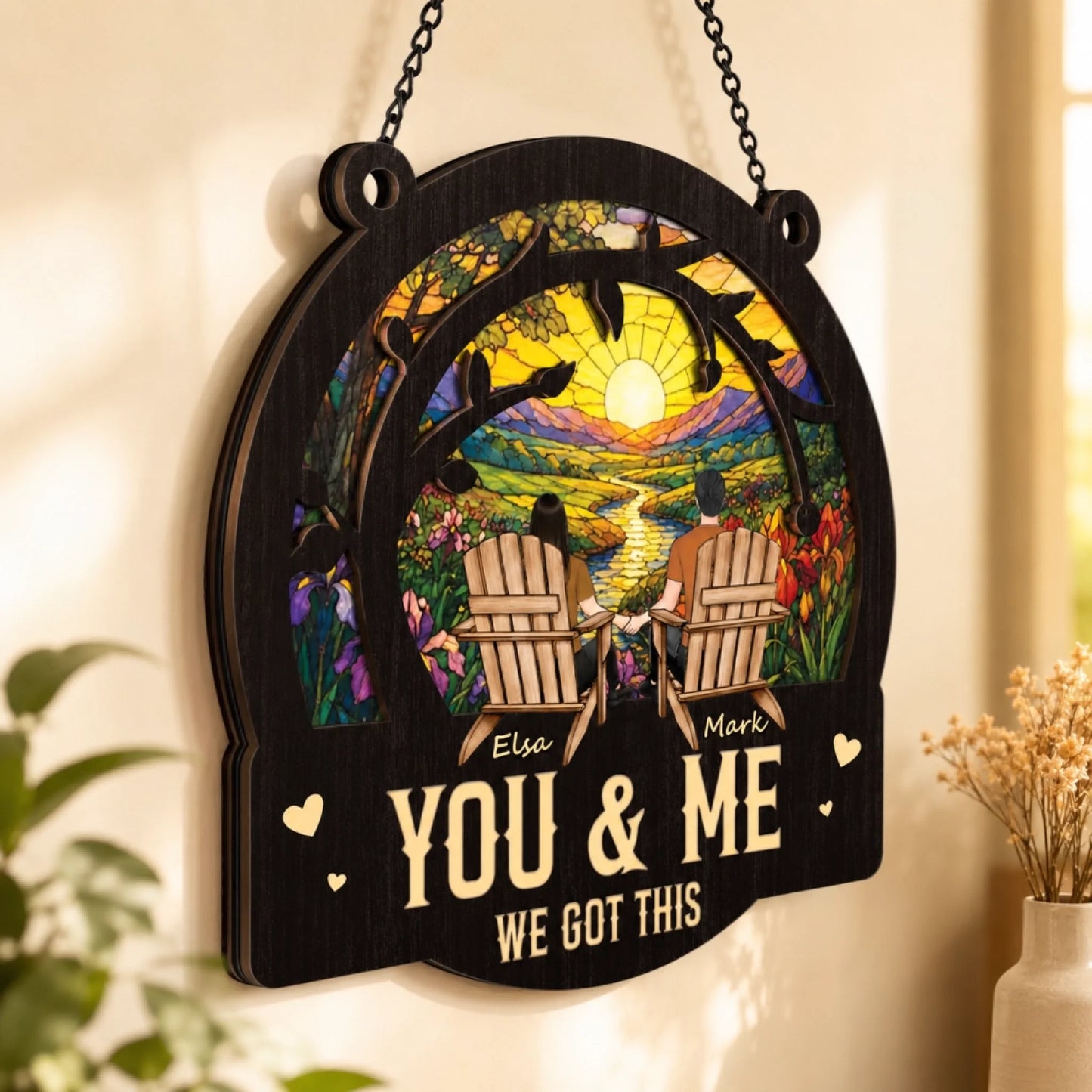 Decorative wall hanging with 'You & Me We Got This' text and a couple in Adirondack chairs.