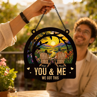 Decorative sign with 'You & Me, We Got This' text held by a person outdoors.