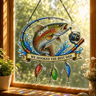 Decorative stained glass panel with a fish and fishing theme, hanging on a window.