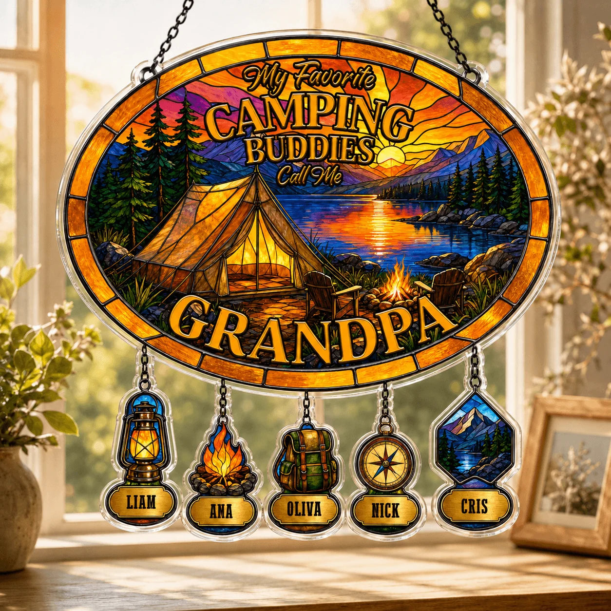 Decorative sign with camping theme and names on a window sill.